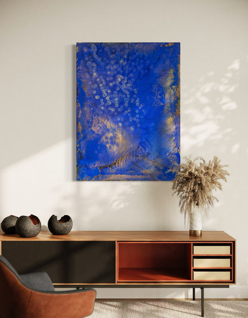 Painting with bright golden tones against deep cobalt, depicting the mesmerizing scene of fireflies illuminating a twilight sky.