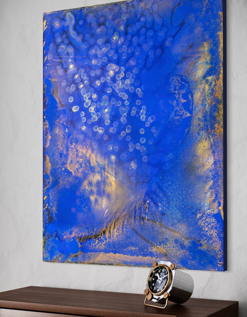 Painting with bright golden tones against deep cobalt, depicting the mesmerizing scene of fireflies illuminating a twilight sky.